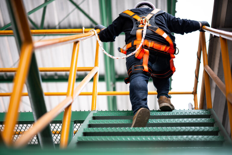 Construction worker walking up steps on site
