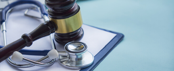 Gavel and stethoscope on a table