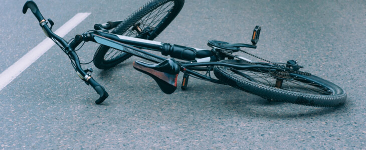 Bicycle lies on the pavement on the roadway. Concept on the theme of the accident