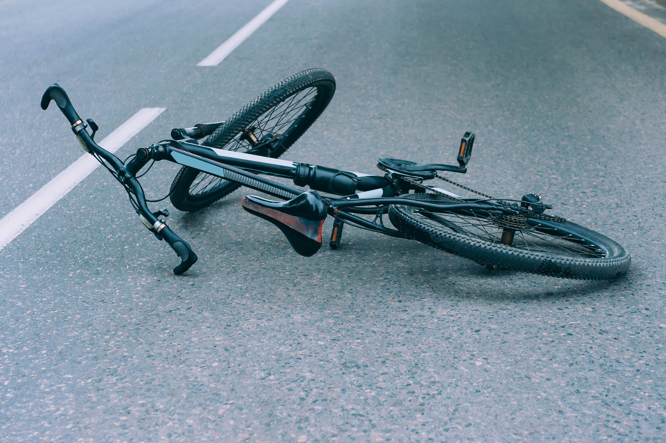 Bicycle lies on the pavement on the roadway. Concept on the theme of the accident